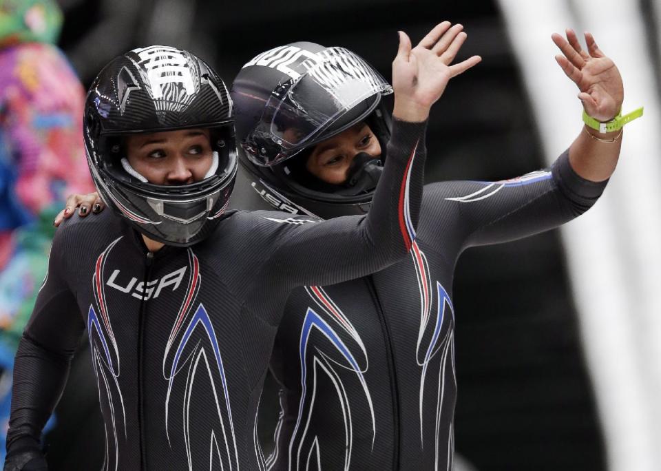 The team from the United States USA-3, piloted by Jazmine Fenlator with brakeman Lolo Jones, left, wave to fans after their final run during the women's bobsled competition at the 2014 Winter Olympics, Wednesday, Feb. 19, 2014, in Krasnaya Polyana, Russia. (AP Photo/Michael Sohn)