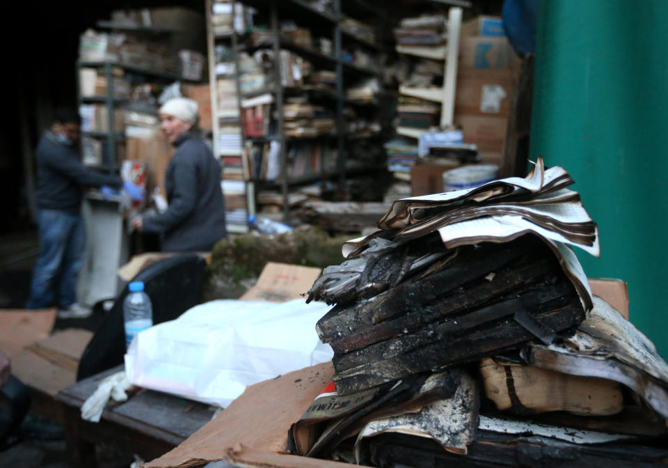 In this picture taken on Sunday, Jan. 5, 2014, burned books are seen in the backyard of the Saeh (Tourist) Library which was set on fire by masked men, in the northern city of Tripoli, Lebanon. Books that were burnt in an arson attack targeting a crammed, chaotic and popular library in the northern Lebanese city of Tripoli have become the latest victim of the country's rising sectarian tensions.(AP Photo/Hussein Malla)