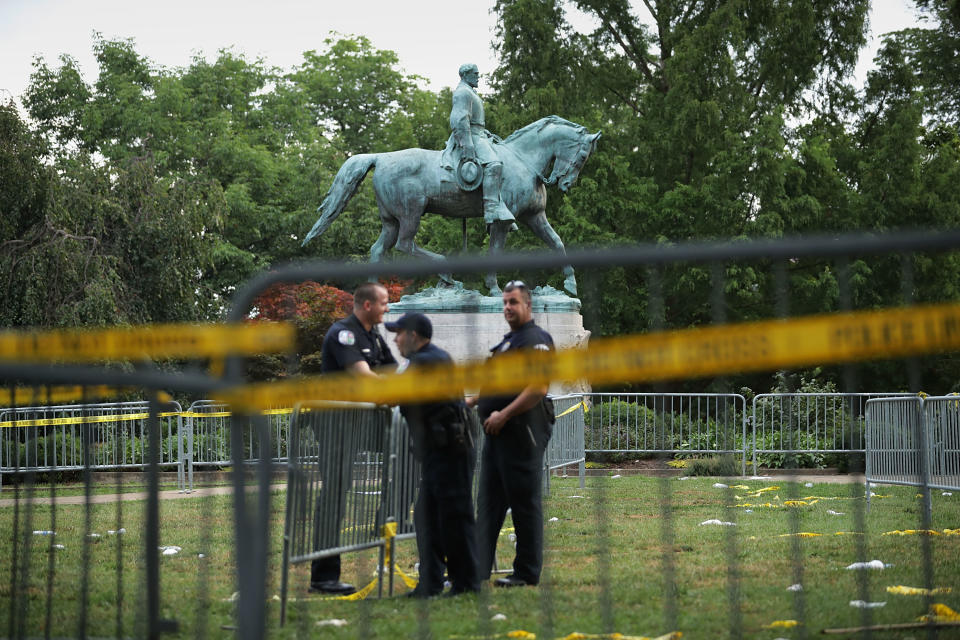 <p>Police stand watch near the statue of Confederate Gen. Robert E. Lee in the center of Emancipation Park the day after the Unite the Right rally devolved into violence Aug.13, 2017 in Charlottesville, Va. The Charlottesville City Council voted to remove the statue and change the name of the space from Lee Park to Emancipation Park, sparking protests from white nationalists, neo-Nazis, the Ku Klux Klan and members of the ‘alt-right.’ (Photo: Chip Somodevilla/Getty Images) </p>