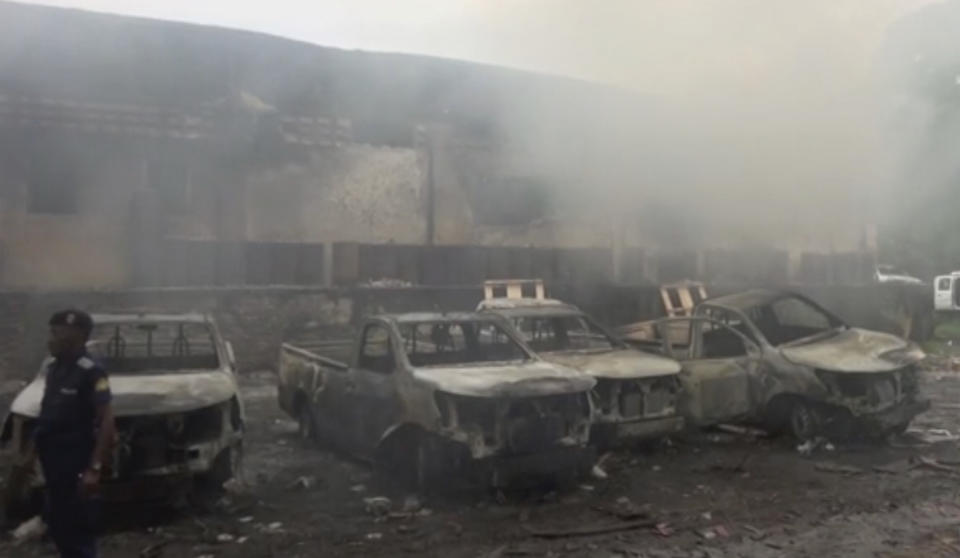 In this image from video, smoke envelopes a building as emergency services attend an early-morning fire in Congo's capital Kinshasa, Thursday Dec. 13, 2018, which is reported to have destroyed thousands of voting machines just 10-days before the upcoming presidential election. Officials said Thursday, the blaze appeared to be criminal in nature but vowed that it would not disrupt the Dec. 23, vote. (AP Photo)