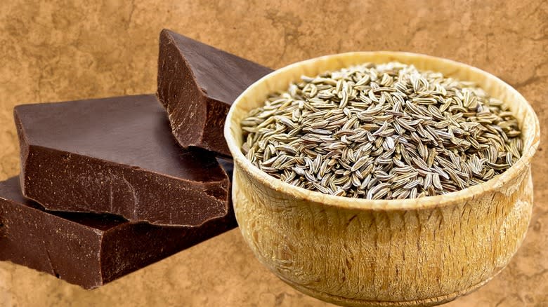 Chocolate beside a bowl of cumin