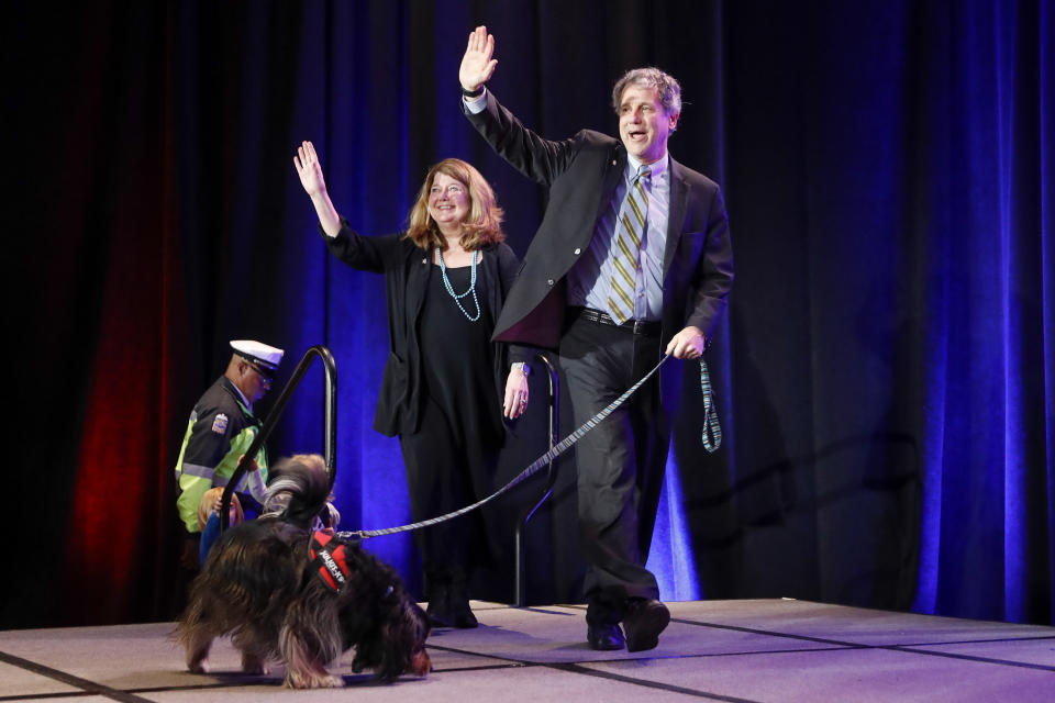 Sen. Sherrod Brown, D-Ohio, right, takes the stage alongside his wife Connie Schultz, left, during the Ohio Democratic Party election night watch party, Tuesday, Nov. 6, 2018, in Columbus, Ohio. (AP Photo/John Minchillo)