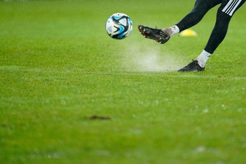 A player kicks the ball before the German DFB Cup quarter final soccer match between 1. FC Saarbruecken and Borussia Moenchengladbach at Ludwigspark Stadium. A German Cup quarter-final between third division Saarbruecken and Borussia Moenchengladbach scheduled for later Wednesday is under threat because of a water-logged pitch. Uwe Anspach/dpa