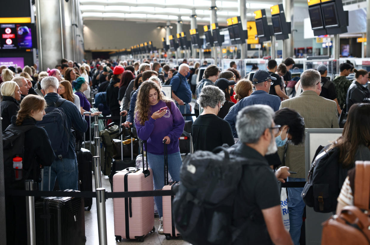 Passengers queue inside the departures terminal of Terminal 2 at Heathrow Airport in London, Britain, June 27, 2022. REUTERS/Henry Nicholls