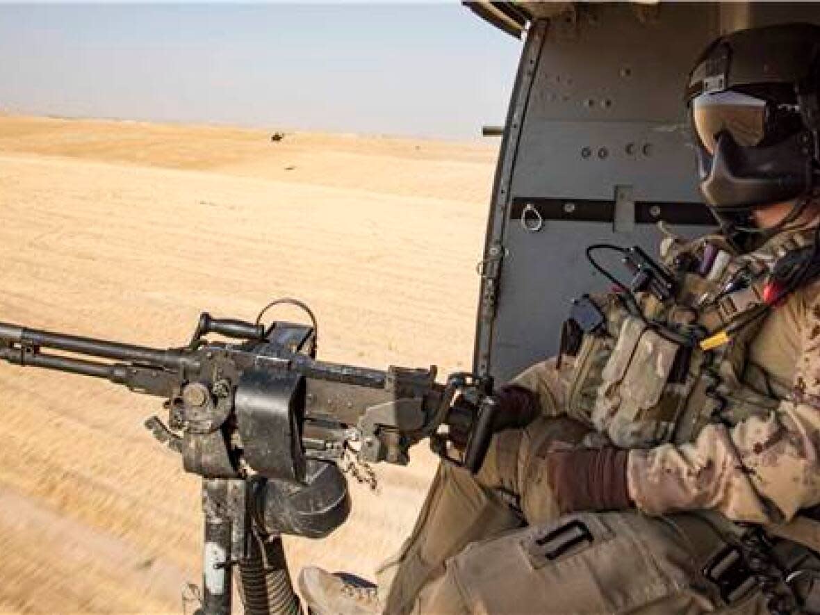 A door gunner with the tactical aviation detachment watches out of a CH-146 Griffon helicopter during Operation IMPACT on September 27, 2017.  (Combat Camera/DND - image credit)