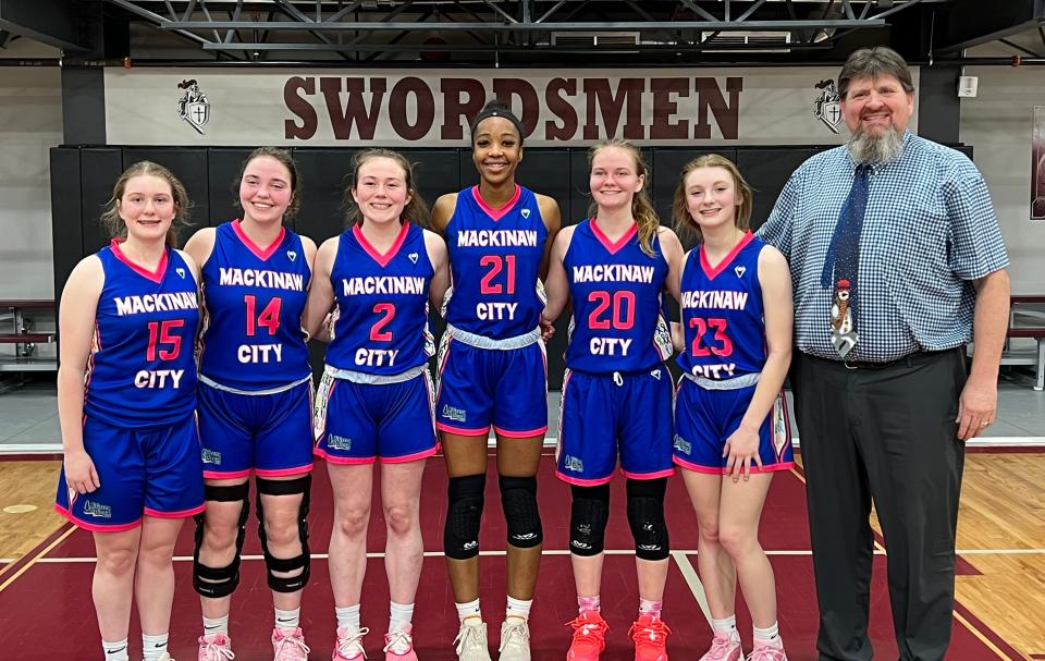 The Mackinaw City girls' basketball team takes a moment for a photo after clinching a sixth straight Northern Lakes Conference title at Harbor Light Christian this week.