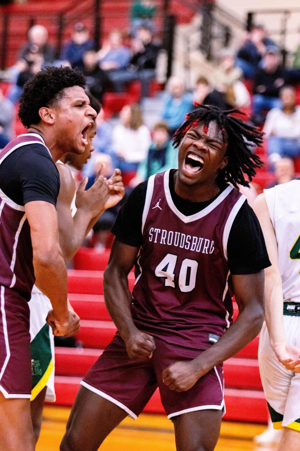 Kamoni Smith-Johnson (right) and Kevin Polonia celebrating a play on the basketball court