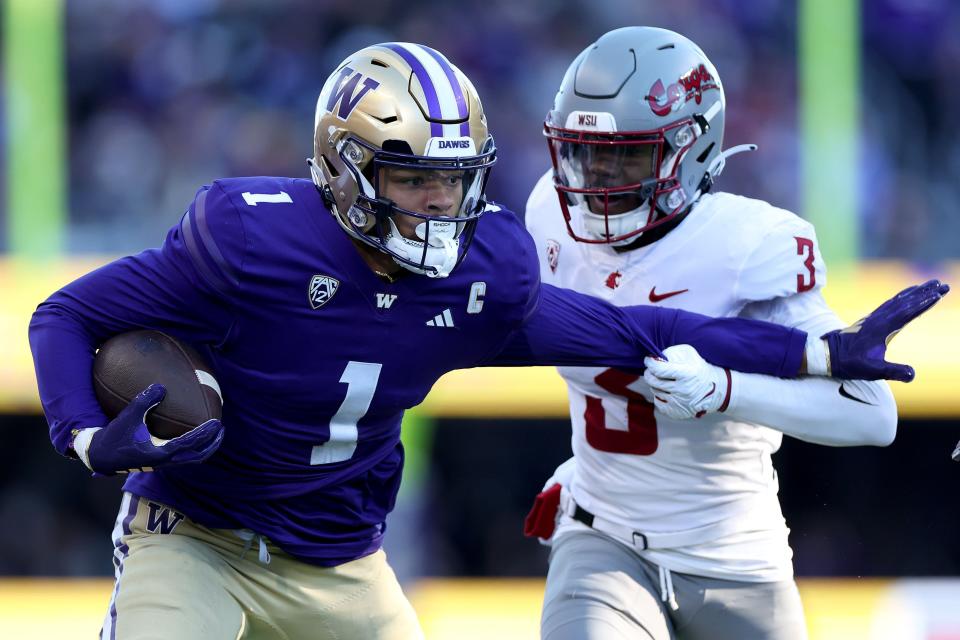 SEATTLE, WASHINGTON - NOVEMBER 25: Cam Lampkin #3 of the Washington State Cougars tackles Rome Odunze #1 of the Washington Huskies during the first quarter at Husky Stadium on November 25, 2023 in Seattle, Washington. (Photo by Steph Chambers/Getty Images)