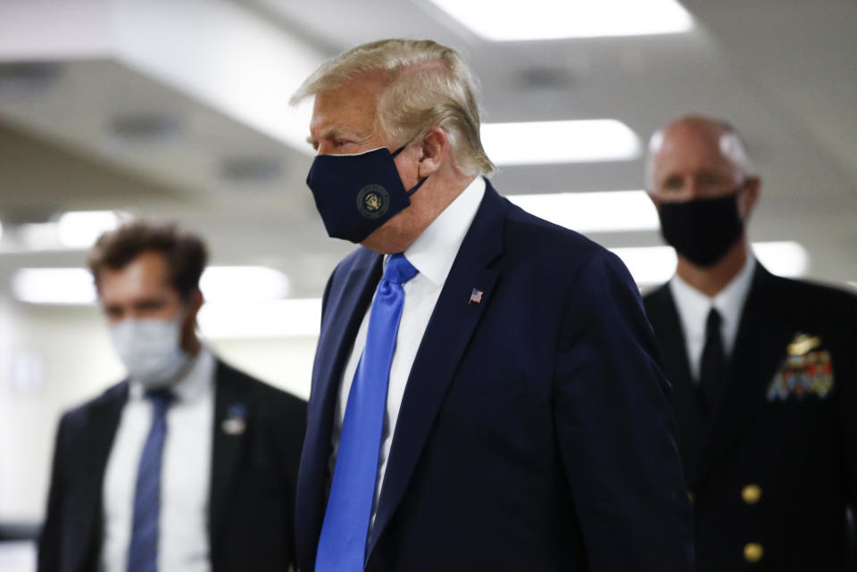 President Donald Trump wears a mask as he walks down the hallway during his visit to Walter Reed National Military Medical Center in Bethesda, Md., Saturday, July 11, 2020. (AP Photo/Patrick Semansky)