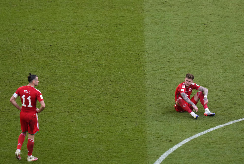 Wales' Gareth Bale, left, and Wales' Joe Rodon react at the end of the World Cup group B soccer match between Wales and Iran, at the Ahmad Bin Ali Stadium in Al Rayyan , Qatar, Friday, Nov. 25, 2022. (AP Photo/Manu Fernandez)