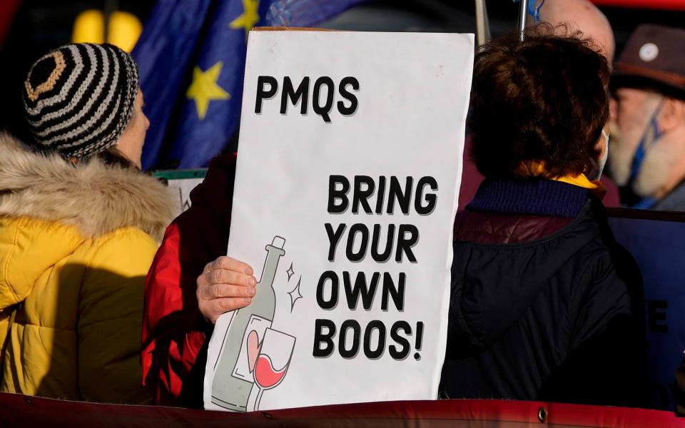 Anti-Tory protesters hold placards in Parliament Square - Frank Augstein/AFP