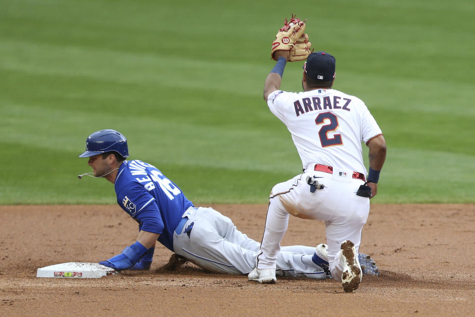 Minnesota Twins second baseman Luis Arraez, right, tags Kansas City Royals' Andrew Benintendi, left, out at second base after trying to steal the base in the first inning of a baseball game Sunday, May 2, 2021, in Minneapolis. (AP Photo/Stacy Bengs)