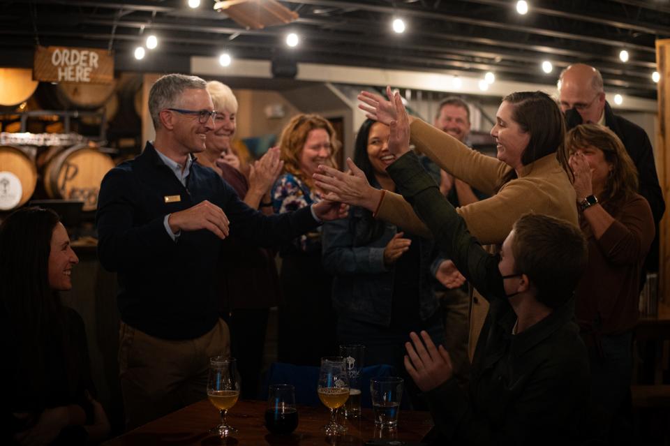 Poudre School District Board of Education candidates Kevin Havelda and Jessica Zamora share a hug after the release of election results during a watch party at Purpose Brewing in Fort Collins, Colo., on Tuesday, Nov. 7, 2023.