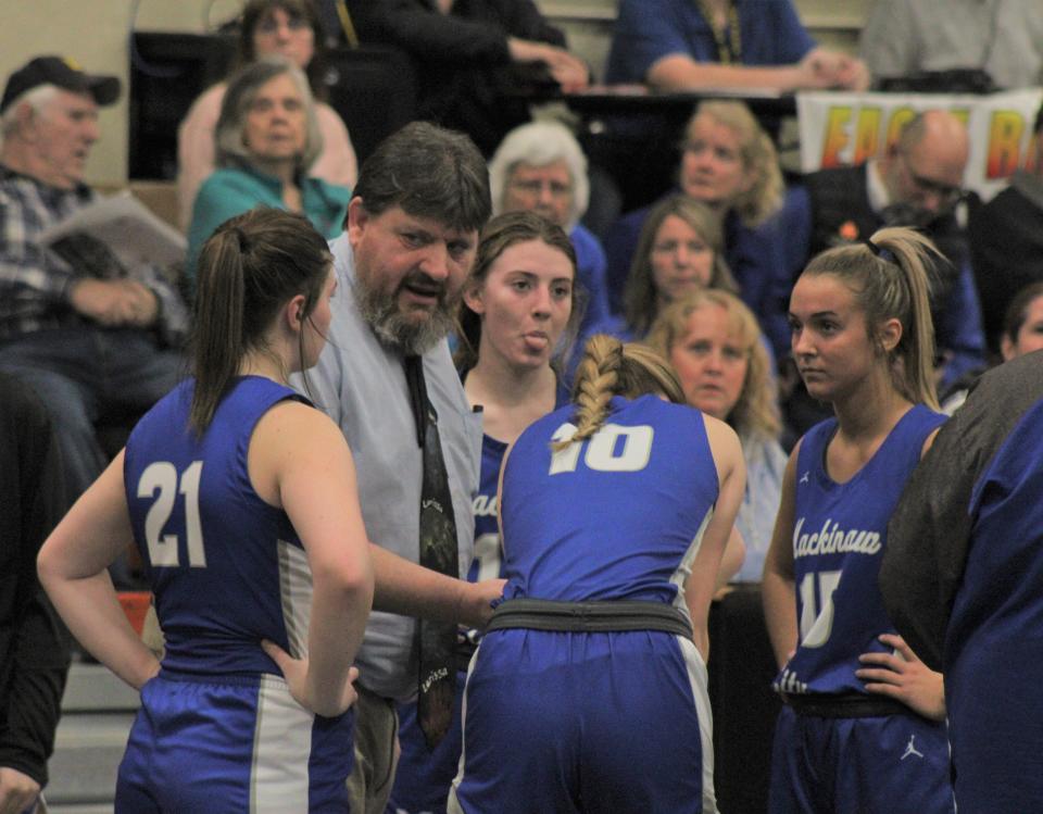 Mackinaw City head coach Jake Huffman talks to his players in a timeout during Tuesday's state quarterfinal clash with Baraga at Munising.