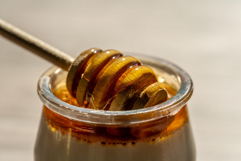 Elevated view of yogurt with honey on wooden table