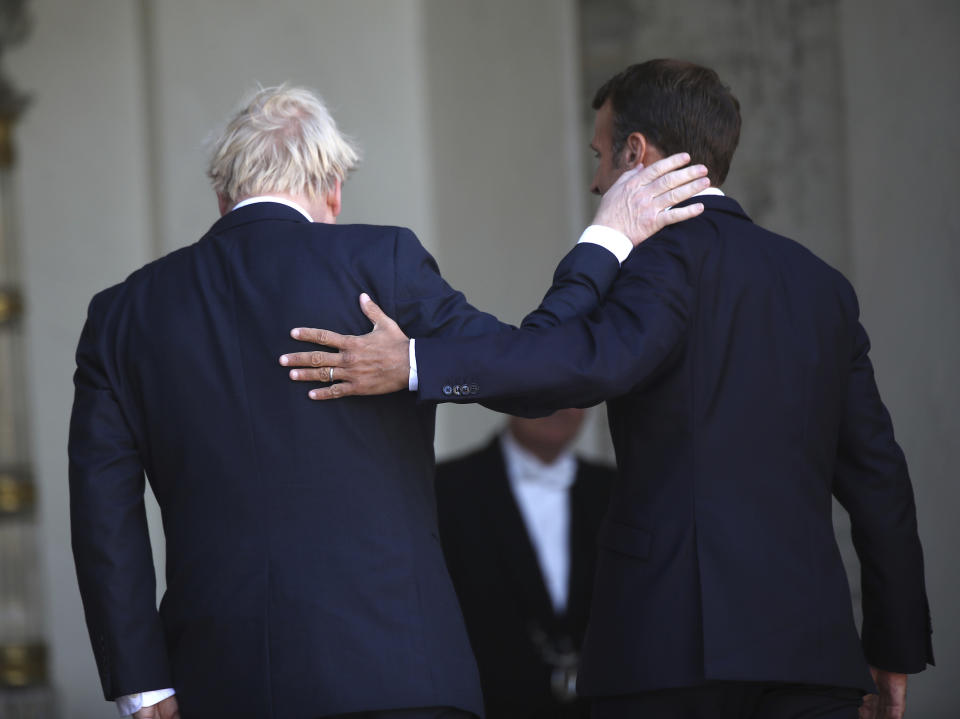 French President Emmanuel Macron, right, and Britain's Prime Minister Boris Johnson walk into the Elysee Palace after addressing the press, Thursday, Aug. 22, 2019 in Paris. Boris Johnson traveled to Berlin Wednesday to meet with Chancellor Angela Merkel before heading to Paris to meet with French President Emmanuel Macron. (AP Photo/Daniel Cole)