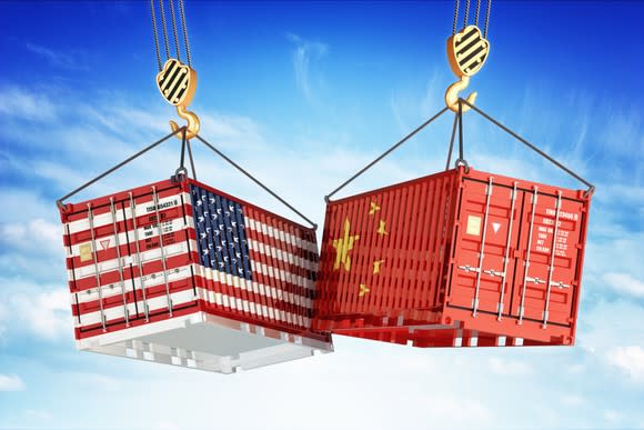 Shipping containers with U.S. and China flag markings.