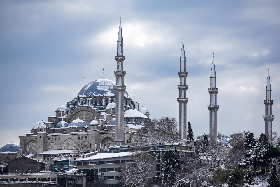 The snow-covered Suleymaniye Mosque at Istanbul, Tuesday, Jan. 25, 2022. Rescue crews in Istanbul and Athens on Tuesday cleared roads that had come to a standstill after a massive cold front and snowstorms hit much of Turkey and Greece, leaving countless people and vehicles in both cities stranded overnight in freezing conditions.(AP Photo/Emrah Gurel)