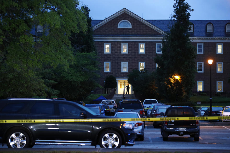 FILE - In this June 1, 2019 file photo, a law enforcement official stands at an entrance to a municipal building that was the scene of a shooting in Virginia Beach, Va. DeWayne Craddock, a city engineer who fatally shot 12 people in a Virginia Beach municipal building in 2019 “was motivated by perceived workplace grievances” that “he fixated on for years,” according to findings released by the FBI on Wednesday, June 9, 2021. (AP Photo/Patrick Semansky)