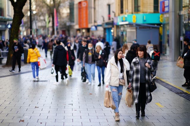 Boxing Day shoppers walk through the centre of Cardiff, Wales, as new Covid-19 rules come into force. (PA)