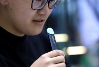 Customer tries a Relx e-cigarette at its flagship store in Beijing