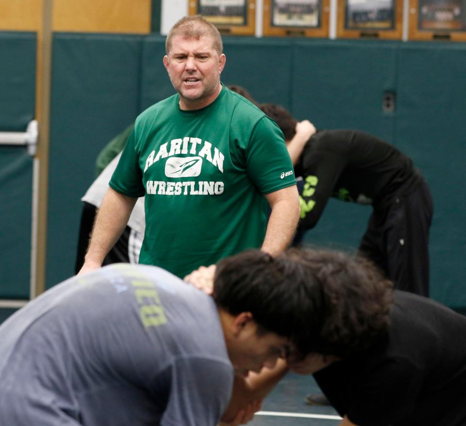 Raritan High School head wrestling coach Rob Nucci (green shirt) is in his final season as the Rockets' head coach.