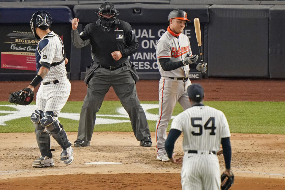 Baltimore Orioles Pat Valaika (11) reacts after striking out for the final out of a 7-0 shoutout loss to the New York Yankees in a baseball game, Monday, April 5, 2021, at Yankee Stadium in New York. Home plate umpire Sam Holbrook calls the strike as Yankees catcher Gary Sanchez, left, checks the call with Yankees relief pitcher Aroldis Chapman (54) on the mound. (AP Photo/Kathy Willens)