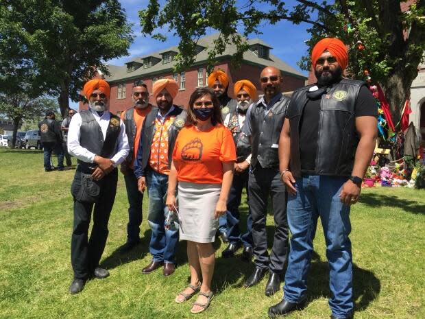 Dozens of riders from the Sikh Motorcycle Club in B.C. arrived in Kamloops on Sunday, June 20 to show their support for the Tk’emlúps te Secwepemc community. Kamloops Indian Band Chief Rosanne Casimir (middle), says the support has meant a lot.  (Jenifer Norwell/CBC - image credit)