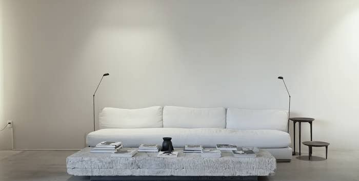 a minimalist room with a table and couch