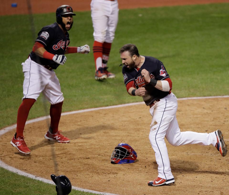 Cleveland Indians' Jason Kipnis and Carlos Santana celebrate after scoring during the fifth inning of Game 7 of the Major League Baseball World Series against the Chicago Cubs Wednesday, Nov. 2, 2016, in Cleveland. (AP Photo/Gene J. Puskar)