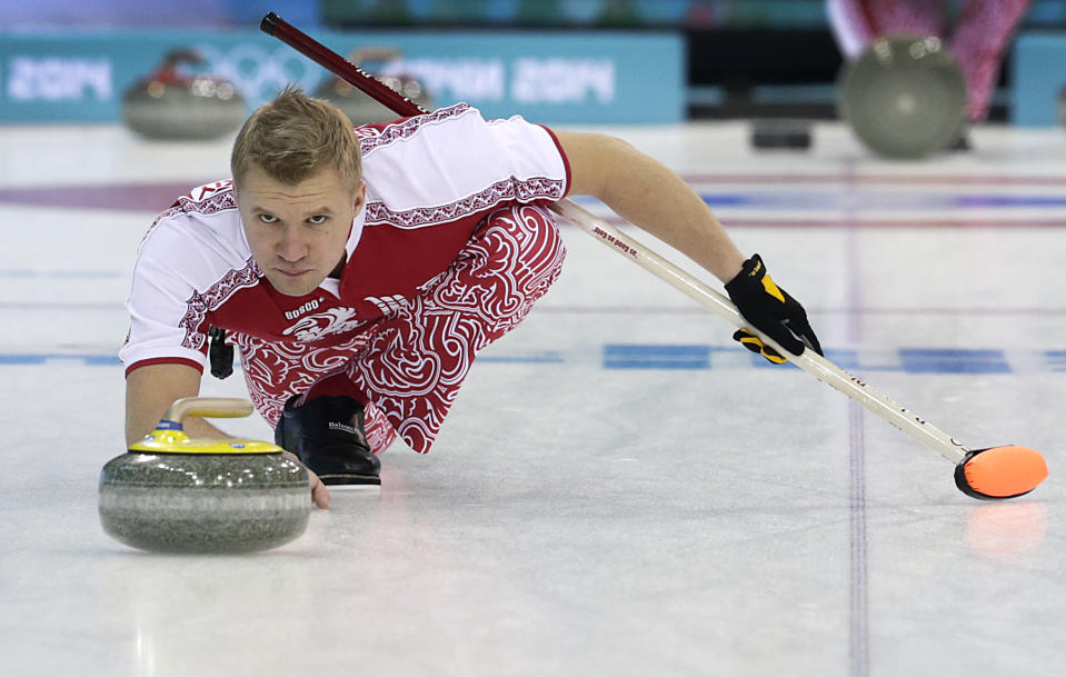 Russia's Alexey Stukalskiy delivers the stone during the first day of the men's curling training at the 2014 Winter Olympics, Saturday, Feb. 8, 2014, in Sochi, Russia. (AP Photo/Wong Maye-E)