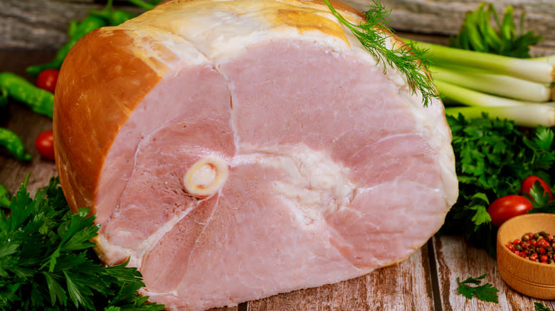 Smoked bone-in ham on wood