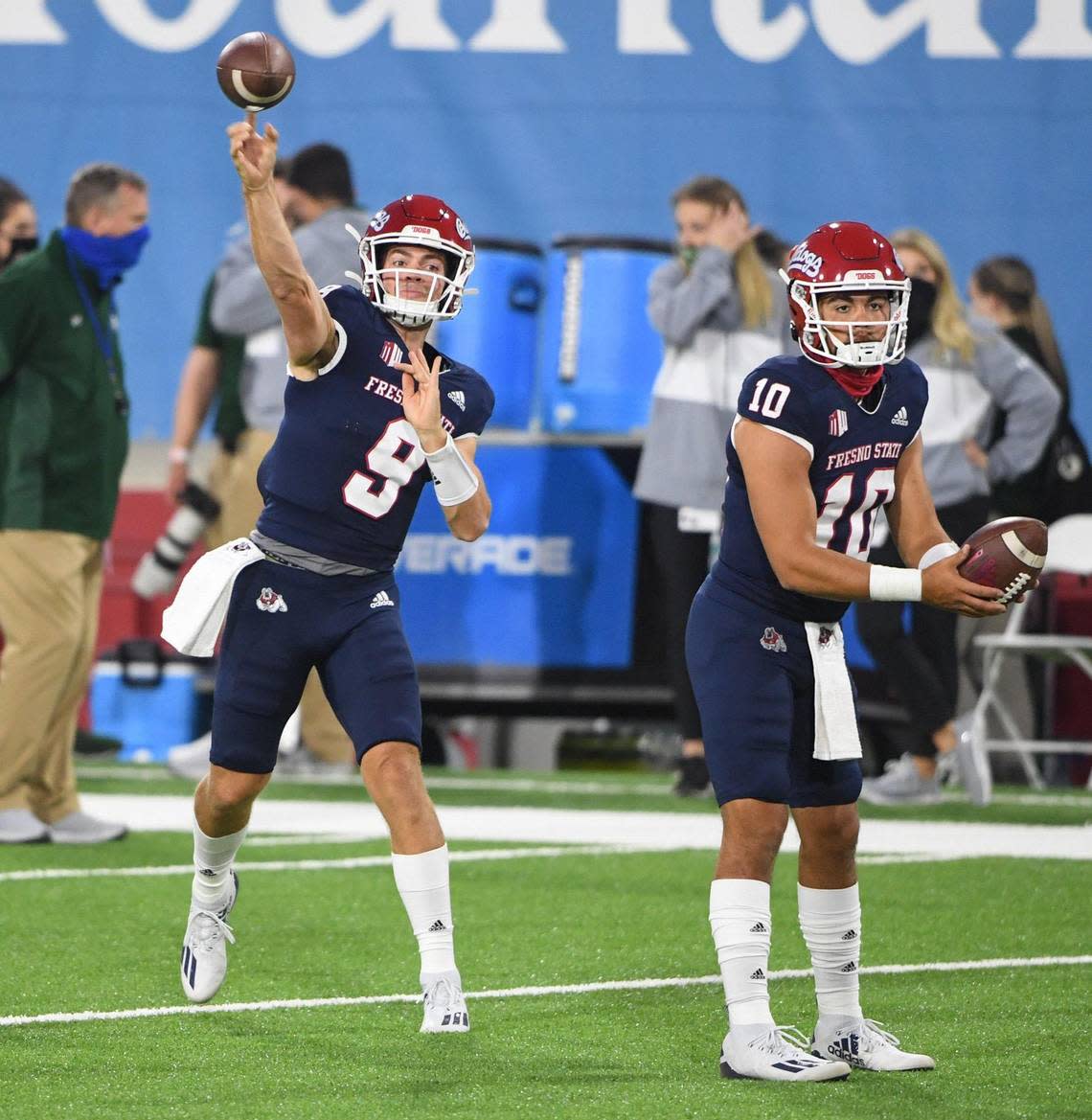 Fresno State quarterback Jake Haener, left, warms up as backup quarterback Logan Fife gets ready for his turn before the start of their game against Colorado State at Bulldog Stadium on Thursday, Oct. 29, 2020.