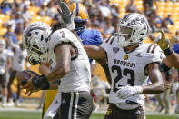 Western Michigan cornerback Dorian Jackson (23) celebrates with linebacker Zaire Barnes (3) after Barnes recovered a Pittsburgh fumble during the first half of an NCAA college football game, Saturday, Sept. 18, 2021, in Pittsburgh. (AP Photo/Keith Srakocic)