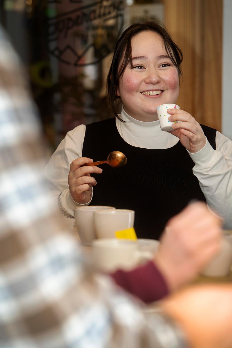 Grace Roberts, a local barista, tastes coffee during a cupping event at Cooperative Coffee Roasters, January 19, 2024. “It was so fun and informative,” said Roberts of the coffee tasting, “I was delighted by the raspberry notes.”
