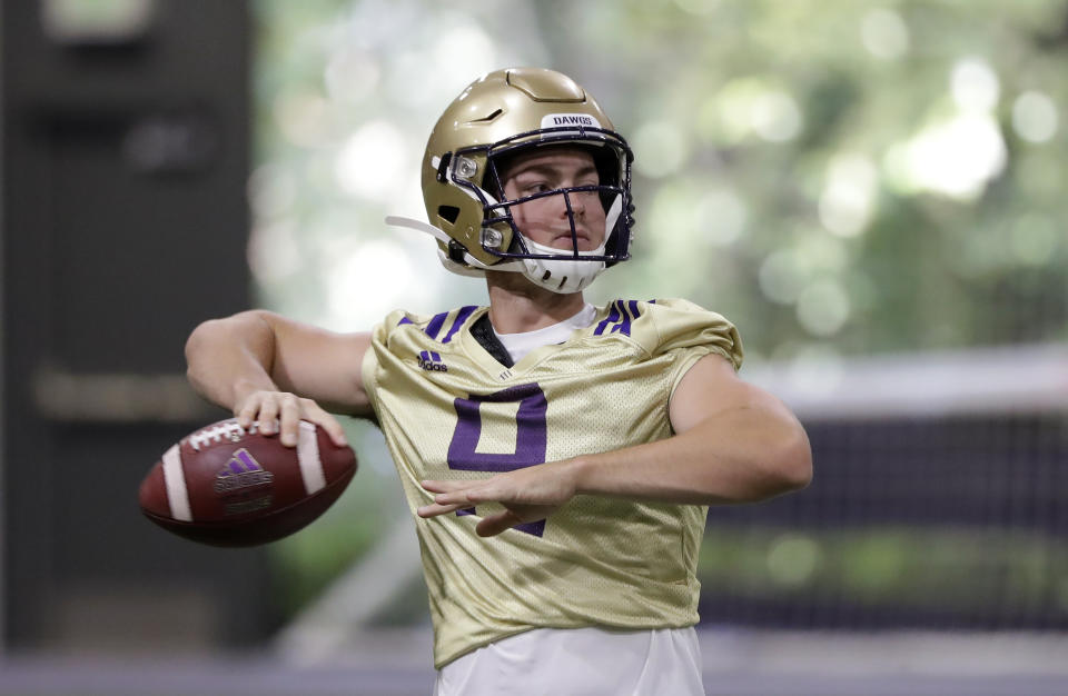 FILE - In this Aug. 5, 2019, file photo, Washington quarterback Jake Haener readies a throw during an NCAA football practice in Seattle. The Huskies could give both Georgia transfer Jacob Eason and Haener snaps in the opener, but would likely want a starter moving forward beginning with Week 2 and a challenging conference opener against California. (AP Photo/Elaine Thompson, File)