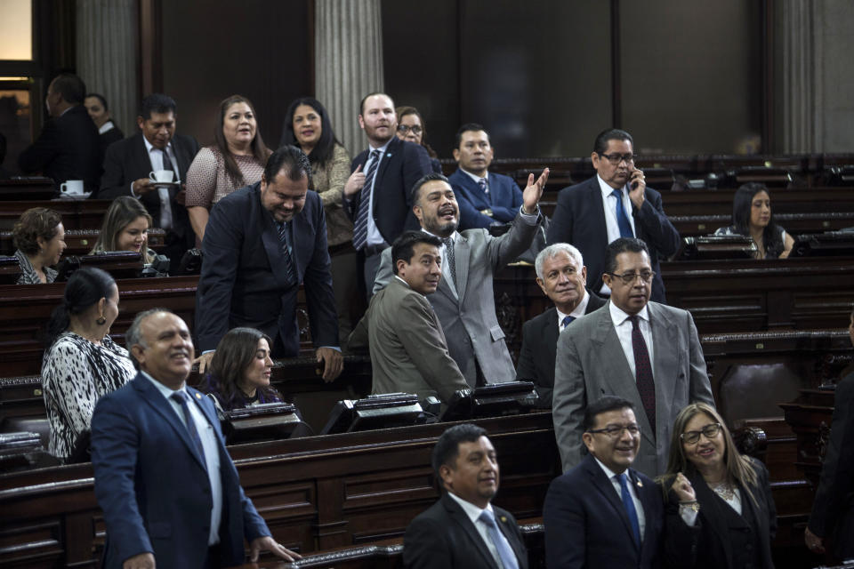 Guatemalan ruling party congressman Javier Hernandez, center, gesticulates during a session in Guatemala City, Wednesday, Dec. 11, 2019. Hernandez is one of the ruling party lawmakers that called for a commission to investigate the U.N.-sponsored anti-graft commission. (AP Photo/Oliver de Ros)