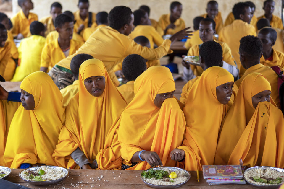 Muchachas de un centro para desplazados fotografiadas en una escuela de las afueras de Dollow (Somalia) el 21 de septiembre del 2022. La escuela les da un almuerzo, un lujo del que pocos disfrutan en el campamento de desplazados. (AP Photo/Jerome Delay).