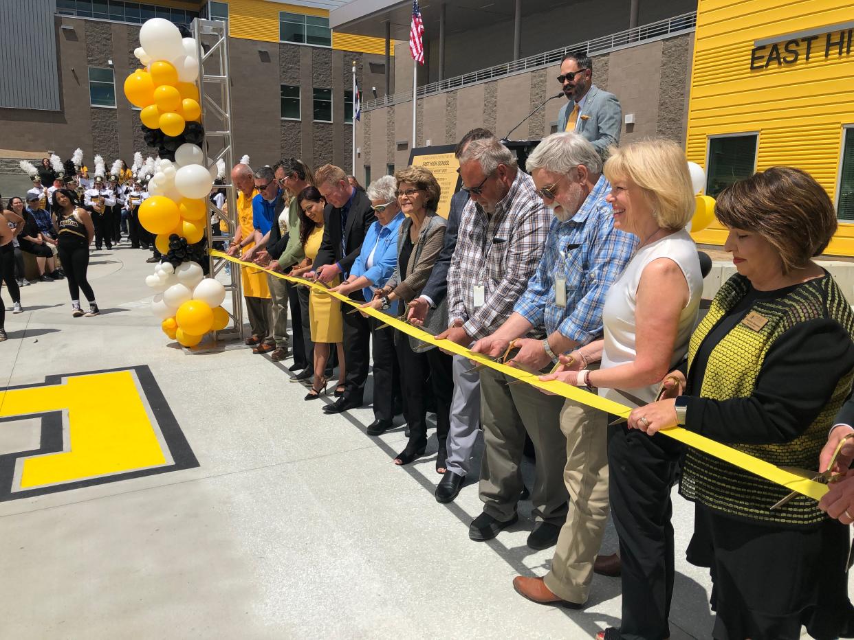 Pueblo School District 60 employees, East High School staff and other stakeholders cut the ribbon for the new school building on May 15, 2023.