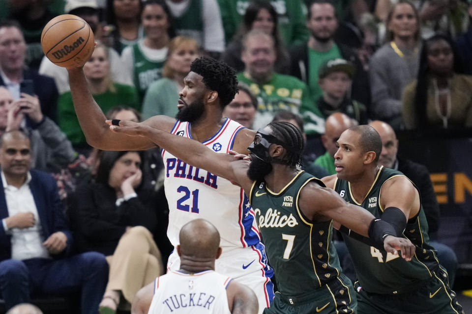 Philadelphia 76ers center Joel Embiid (21) is pressured by Boston Celtics guard Jaylen Brown (7) during the first half of Game 5 in an NBA basketball playoffs Eastern Conference semifinal Tuesday, May 9, 2023, in Boston. (AP Photo/Charles Krupa)