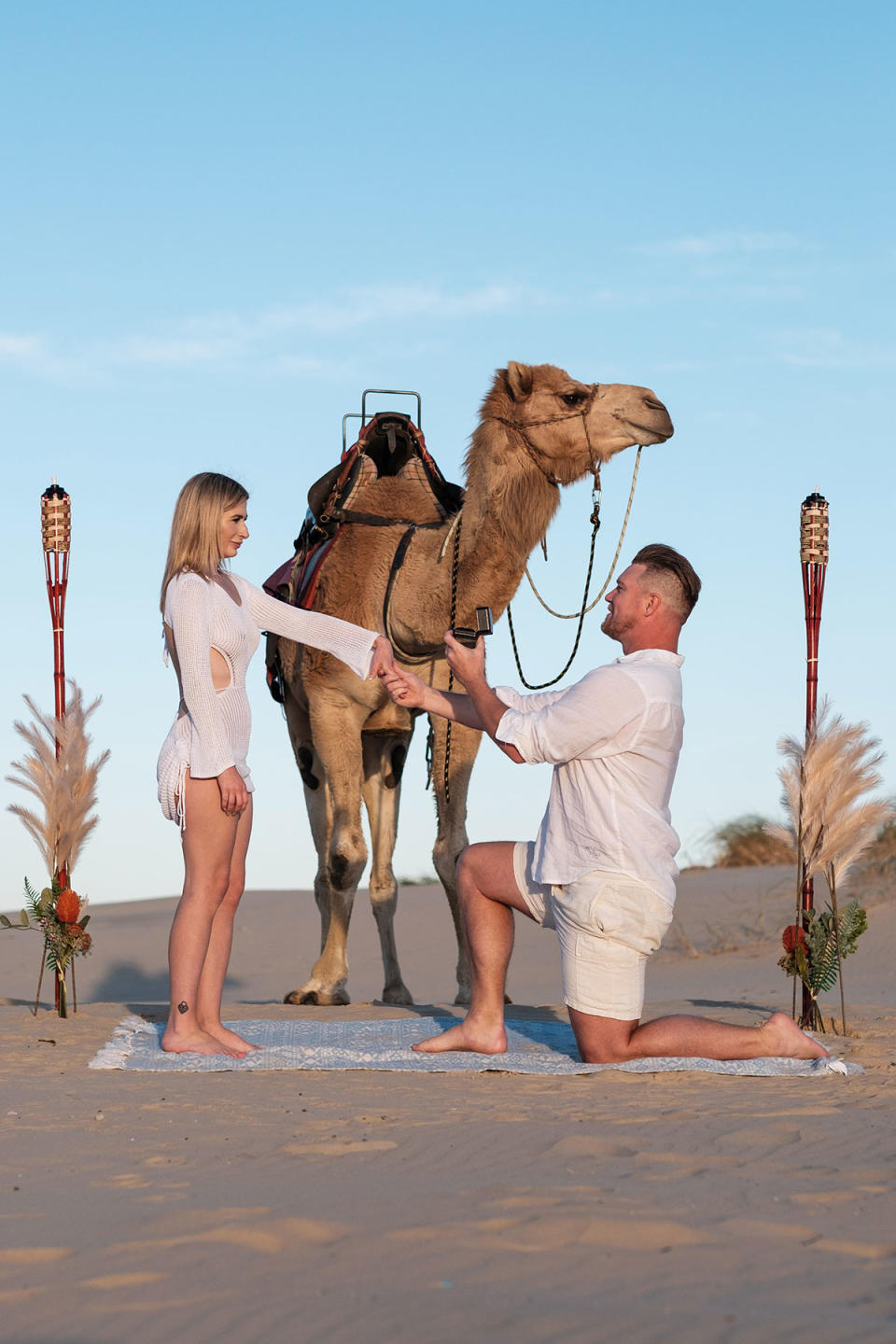 Dean Wells asks Aimee Woolley to be his wife with a camel in front of them