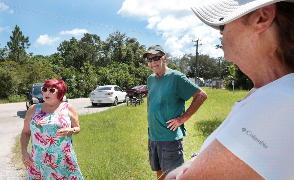 Bear Creek Village residents Fran Canfield, Walter McGovern and Patricia Franzem gather outside the back gate to Bear Creek Village on Hull Road on Wednesday August 9, 2023, while talking about their concernes for the development of a proposed fuel distribution facility planned near their community.