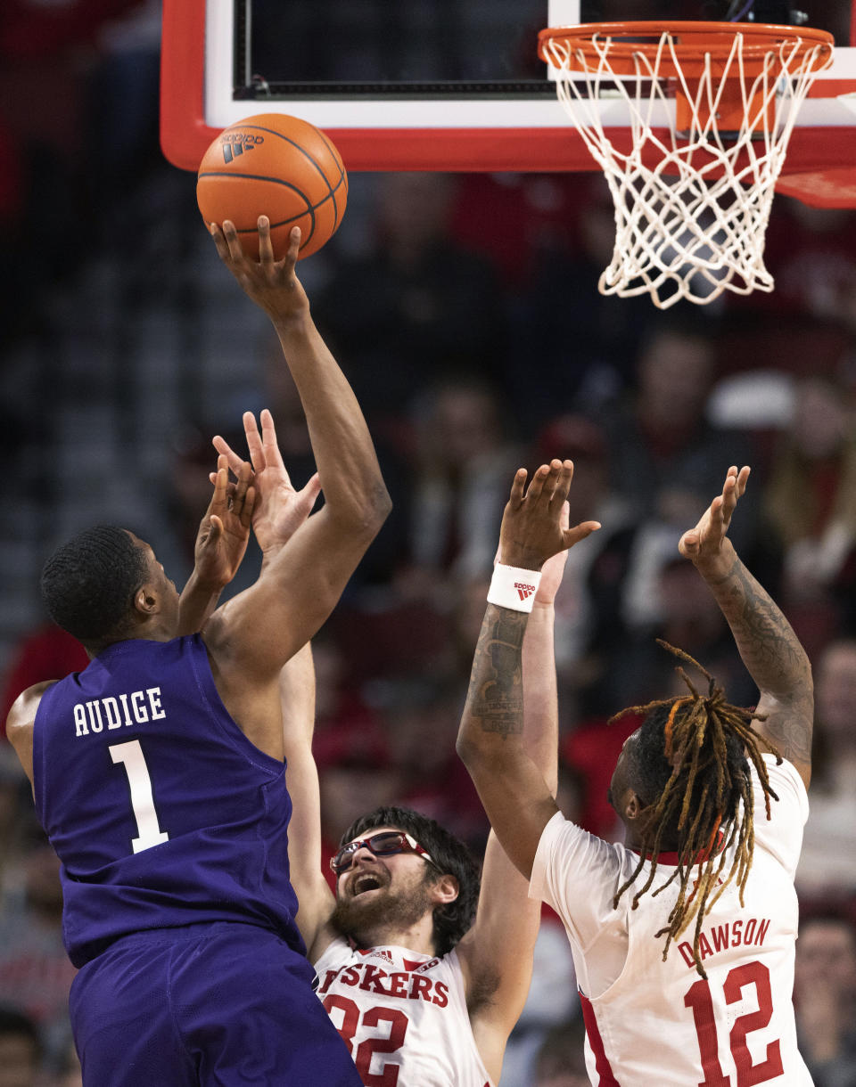 Northwestern's Chase Audige (1) shoots against Nebraska's Wilhelm Breidenbach (32) and Denim Dawson (12) during the first half of an NCAA college basketball game Wednesday, Jan. 25, 2023, in Lincoln, Neb. (AP Photo/Rebecca S. Gratz)