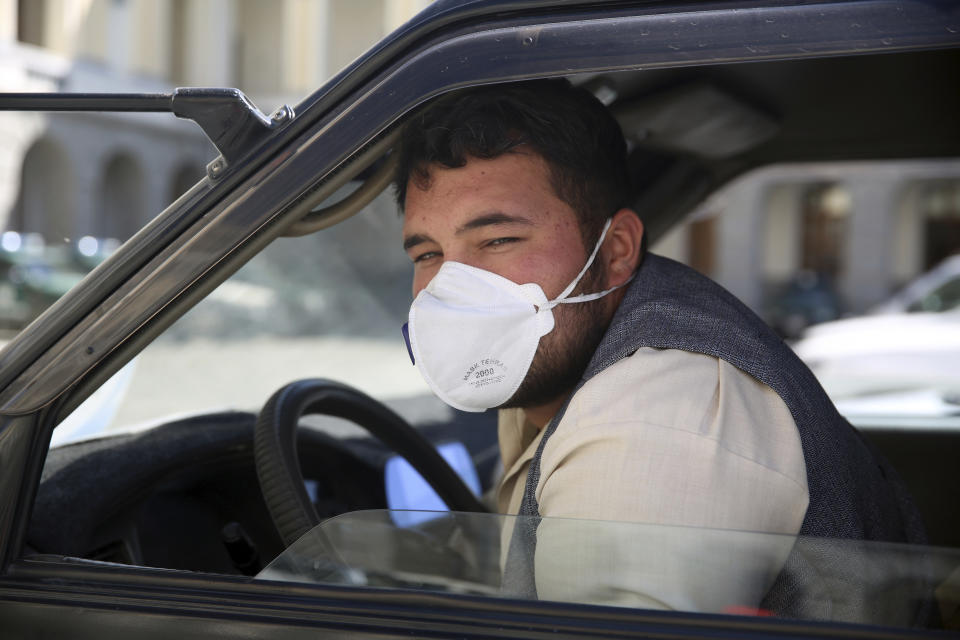 A motorist wears a protective face mask to help curb the spread of the coronavirus in Kabul, Afghanistan, Saturday, April 18, 2020. (AP Photo/Rahmat Gul)