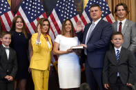 House Speaker Nancy Pelosi of Calif., third from left, conducts a ceremonial swearing-in for Rep. Brad Finstad, R-Minn., third from right, joined by his wife Jaclyn, center, and their family, Friday, Aug. 12, 2022, on Capitol Hill in Washington. (AP Photo/Patrick Semansky)