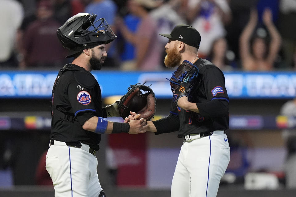 New York Mets pitcher Reed Garrett, right, celebrates with catcher Tomás Nido, left, after a baseball game against the Arizona Diamondbacks, Friday, May 31, 2024, in New York. (AP Photo/Frank Franklin II)