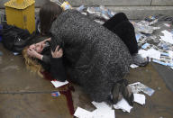 <p>Witnessing the Immediate Aftermath of an Attack in the Heart of London: A passerby comforts U.S. tourist Melissa Cochran, injured in an attack on pedestrians at Westminster Bridge in London, UK, March 22, 2017. Melissa survived, but lost her husband, Kurt, in the attack.<br>On March 22, Khalid Masood drove a rented SUV along the sidewalk of Westminster Bridge, near the British Houses of Parliament in central London. Three people were killed instantly, and two more died in the days after the attack; at least 40 were injured.<br>Armed with two knives, Masood left the car and attempted to enter the grounds of parliament, where he fatally stabbed one of the policemen who tried to stop him, before being shot and killed.<br>Born Adrian Russell Elms in Kent, UK, Masood changed his name when he converted to Islam. Although ISIS claimed responsibility for the attack the following day, police investigating found no evidence of any links between Masood and either ISIS or al-Qaeda. (Photo: Toby Melville/Reuters) </p>