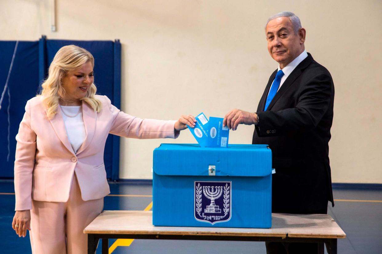 Israeli Prime Minister Benjamin Netanyahu and his wife Sara casts their votes at a voting station in Jerusalem: AFP/Getty Images