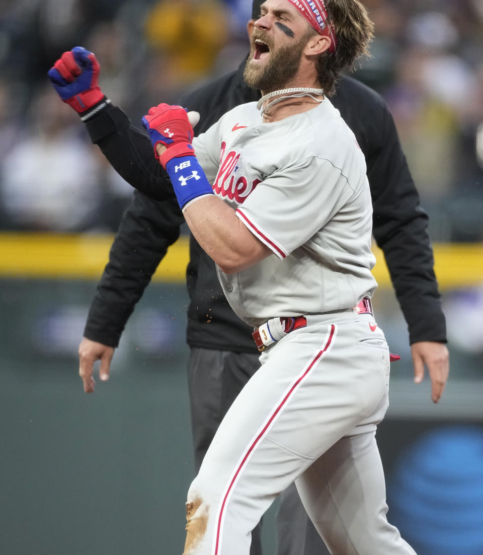 Philadelphia Phillies' Bryce Harper reacts after reaching second base with a double off Colorado Rockies starting pitcher Ryan Feltner during the second inning of a baseball game Saturday, May 13, 2023, in Denver. (AP Photo/David Zalubowski)