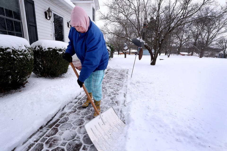 Vicki Williams shovels her sidewalk in front of her home on Lynnford Drive on Tuesday, Jan. 16, 2024, after snow began falling on Sunday and continued through Monday afternoon. Williams removed the snow since her house is going on the market on Wednesday.